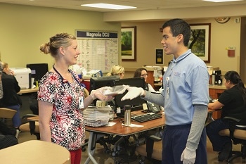 A junior volunteer assisting a caregiver