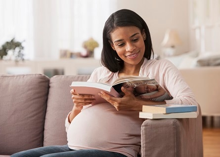 Pregnant woman reading a book