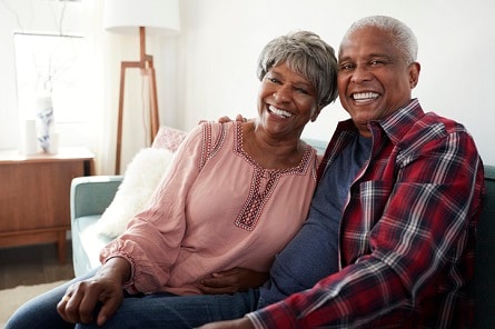 Happy couple sitting inside