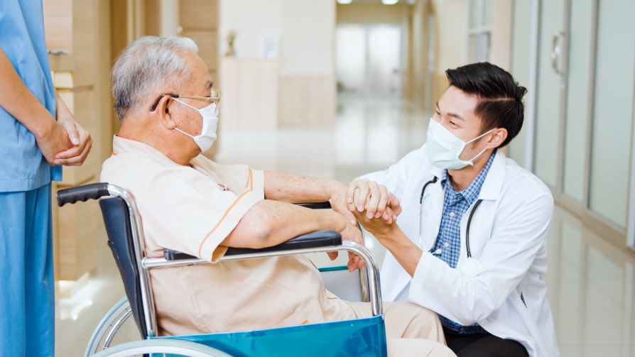 doctor holding a patient's hand