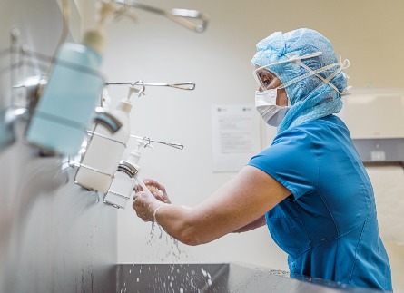 Caregiver washing her hands.