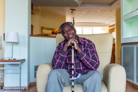 man sitting in a chair smiling