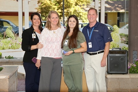 Krystal Hassett accepts her Stories of Excellence award