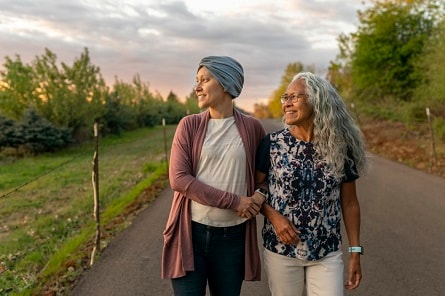 Woman With Cancer Walking With Loved One