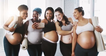 Group of pregnant woman taking a selfie after a workout.