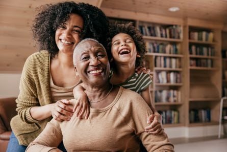 three generations of people smiling together