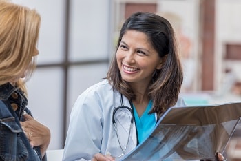 Doctor with patient holding x-ray