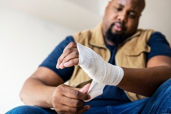 Man with wound on his hand