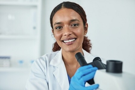 Researcher working with a microscope