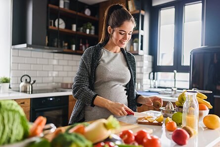 Pregnant woman preparing a healthy meal