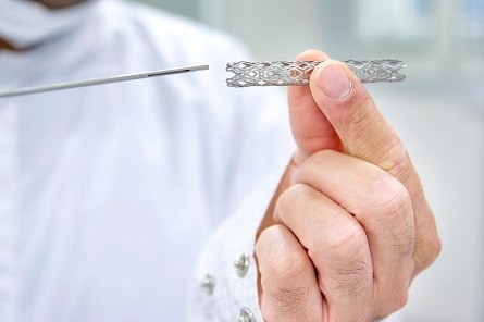 Physician holding heart stent