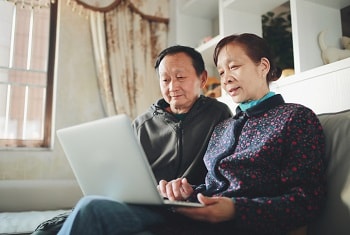 Older couple paying a bill online