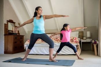 Mother and daughter doing yoga