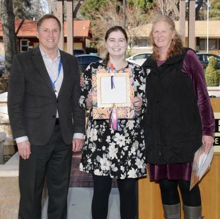 Ashlee Ward accepting a Stories of Excellence award