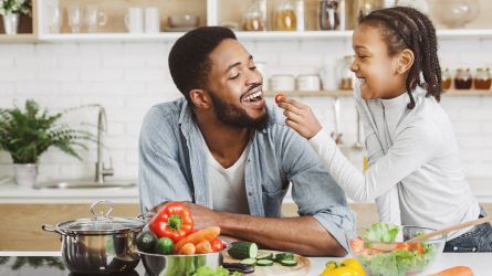 father and daughter sharing food