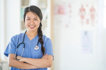 caregiver smiling and crossing arms