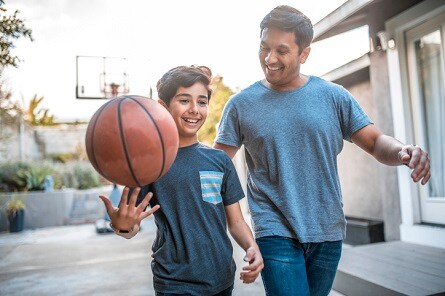 Father and son playing basketball