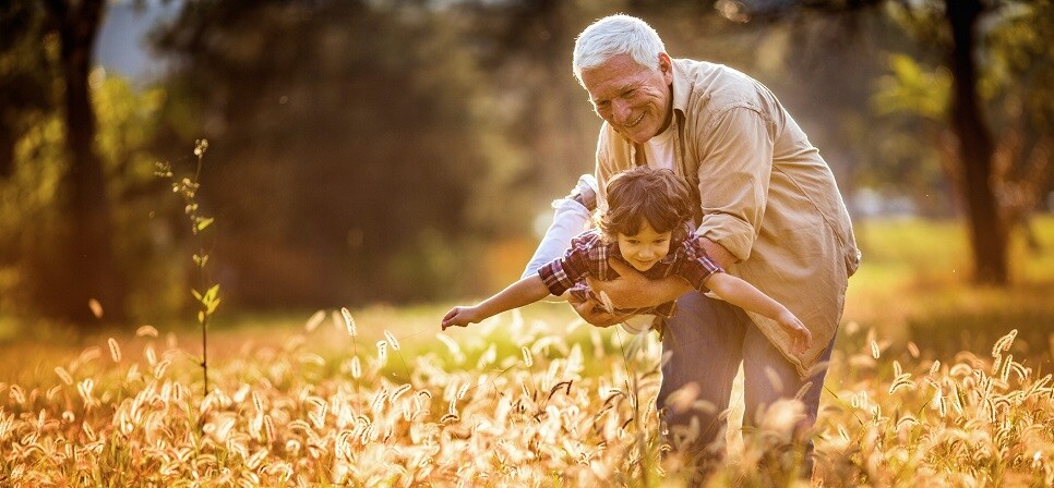 Grandpa with grandchild playing outside