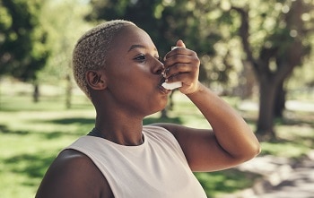 Woman with asthma inhaler