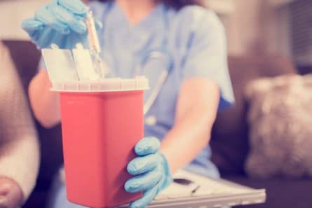 caregiver disposing of medical waste