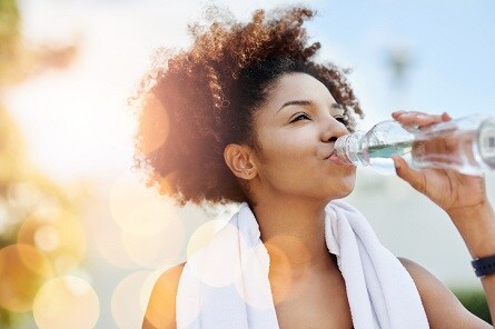 Happy woman drinking water